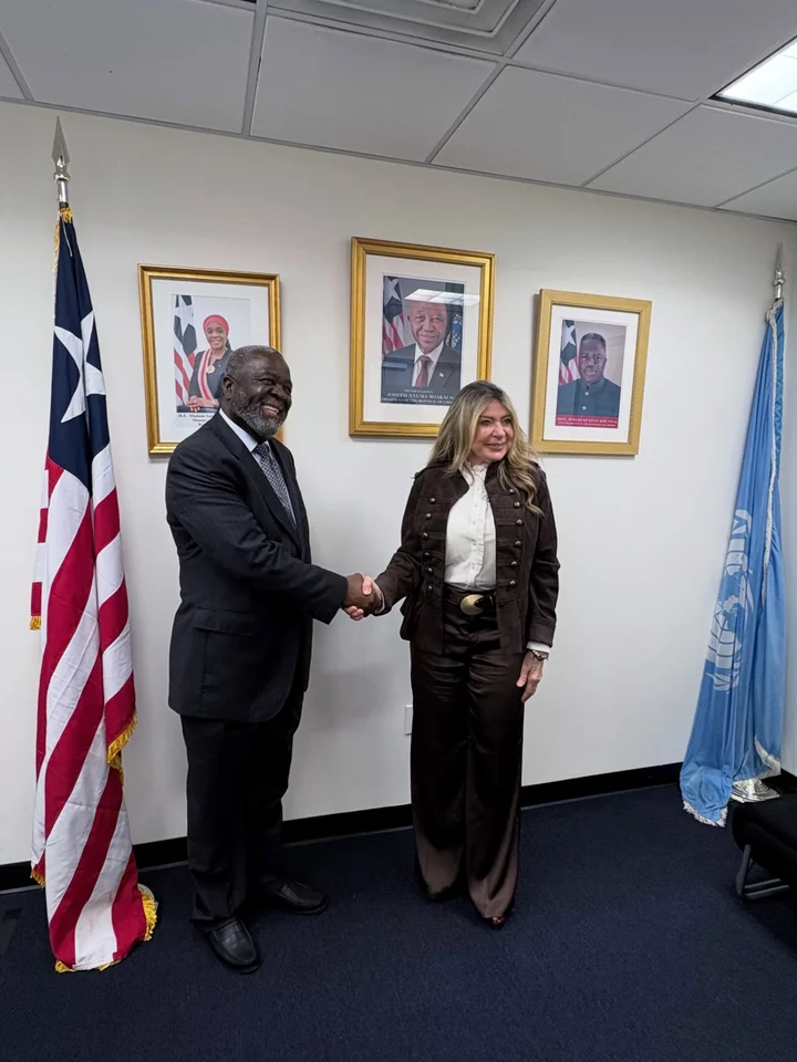 Ivonne A-Baki with Ambassador Lewis Brown.